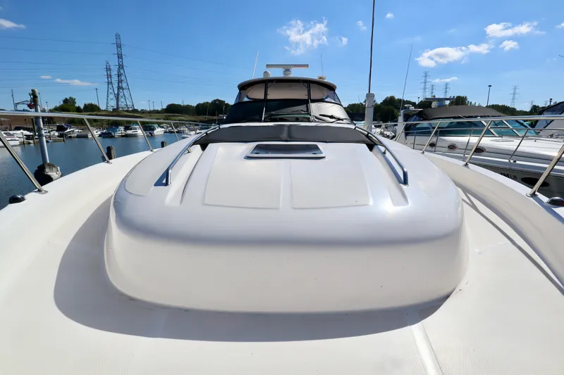 Slide: The Image of 2001 Sea Ray 460 Sundancer yacht docked at marina under clear blue sky. - 36