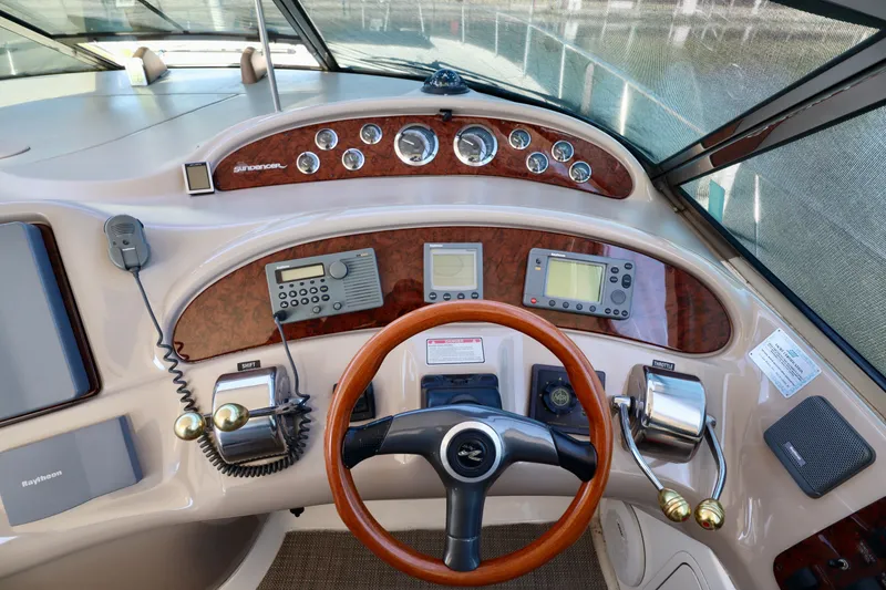 Slide: The Image of 2001 Sea Ray 460 Sundancer helm with wood accents and modern navigation equipment. - 37