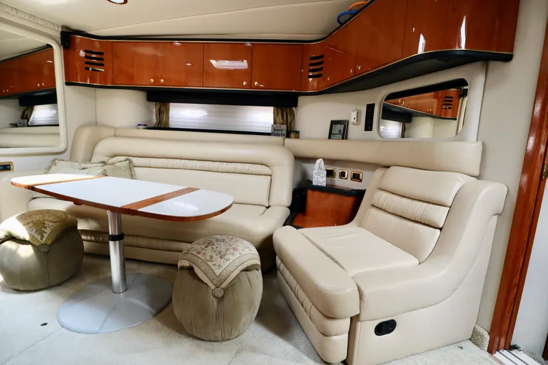 Slide: The Image of Luxurious interior of 2001 Sea Ray 460 Sundancer yacht with beige seating and wooden accents. - 4