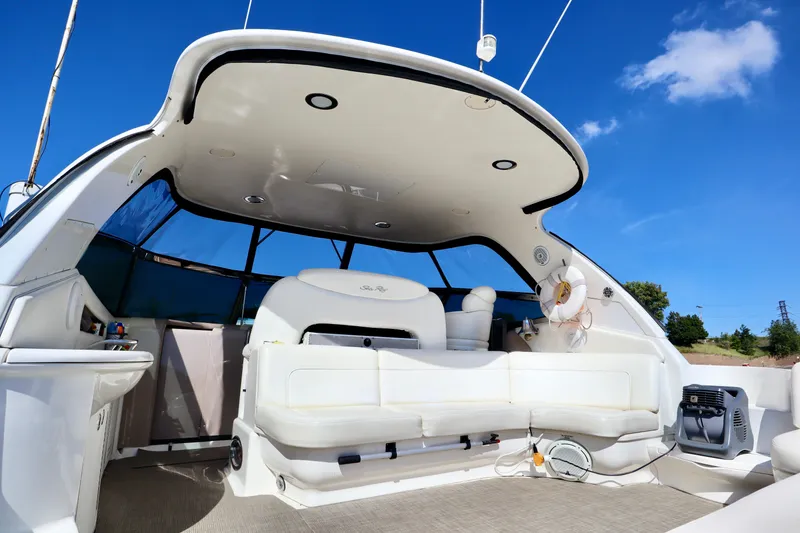 Slide: The Image of 2001 Sea Ray 460 Sundancer yacht interior with white seating and blue sky background. - 40
