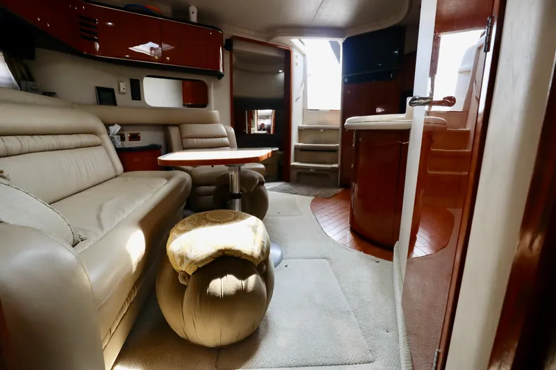Slide: The Image of Interior of 2001 Sea Ray 460 Sundancer yacht with beige seating and wooden accents. - 42