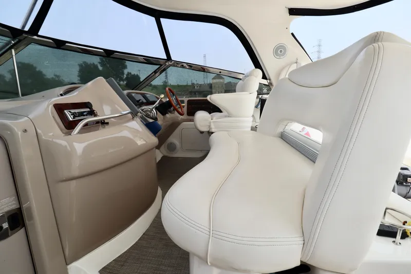 Slide: The Image of 2001 Sea Ray 460 Sundancer helm with white leather seating and modern controls. - 43