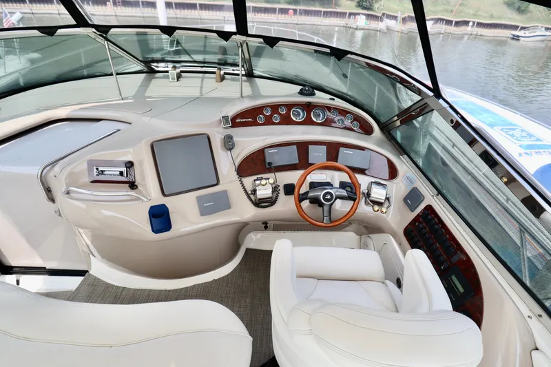 Slide: The Image of Cockpit of 2001 Sea Ray 460 Sundancer yacht with modern controls and leather seating. - 44