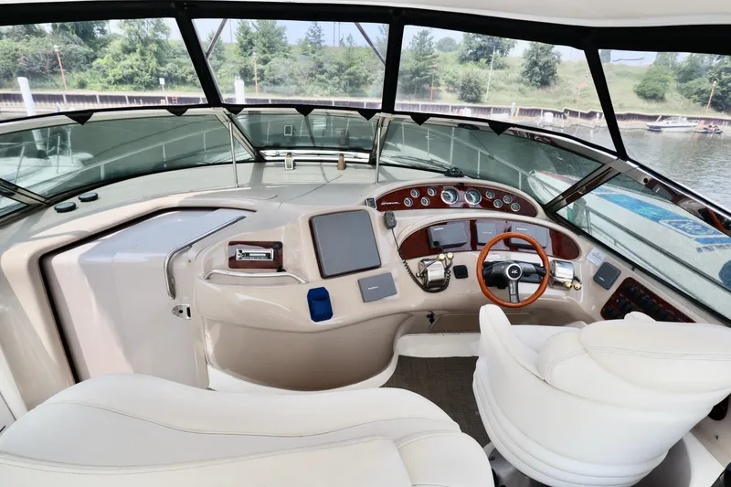Slide: The Image of 2001 Sea Ray 460 Sundancer helm with modern controls and panoramic view. - 45