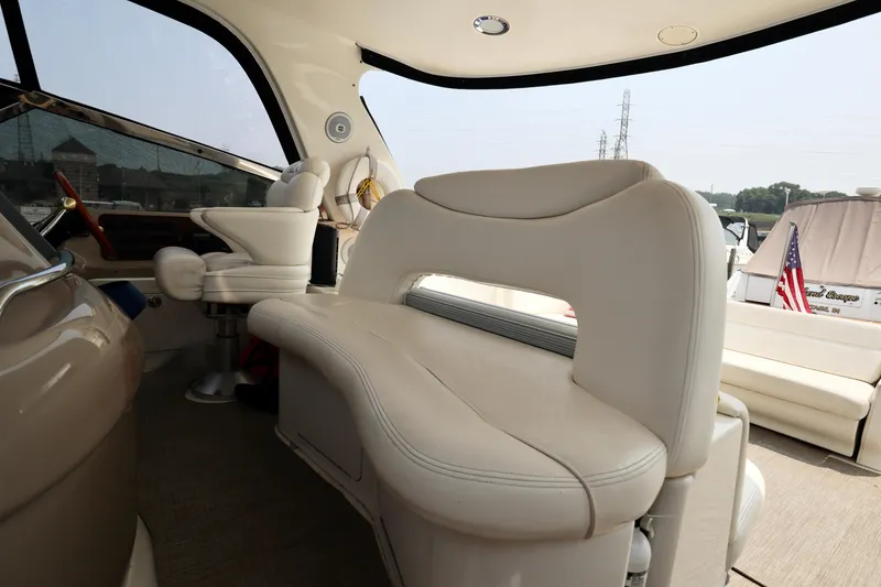 Slide: The Image of Interior of 2001 Sea Ray 460 Sundancer yacht with plush seating and helm station. - 46