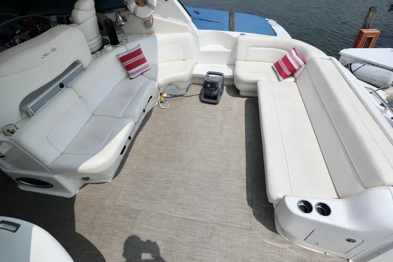 Slide: The Image of 2001 Sea Ray 460 Sundancer boat interior with white seating and striped cushions. - 7