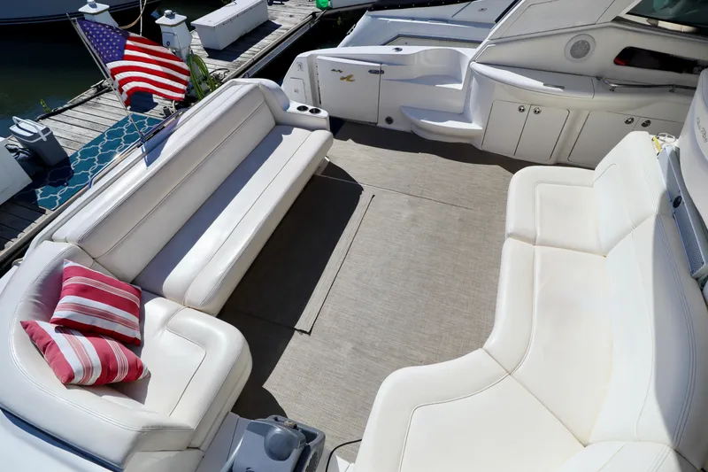 Slide: The Image of 2001 Sea Ray 460 Sundancer yacht interior with white seating and striped cushions. - 9