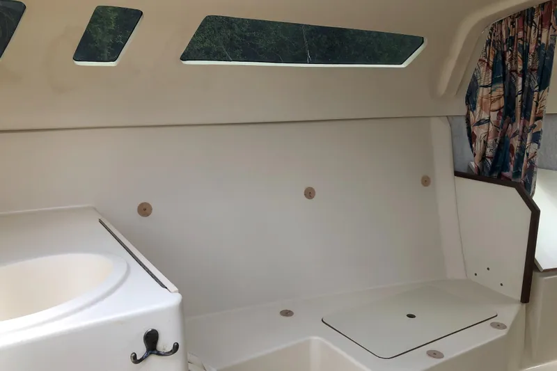 Slide: The Image of Interior of 1998 Hunter 240 sailboat with seating and windows. - 14