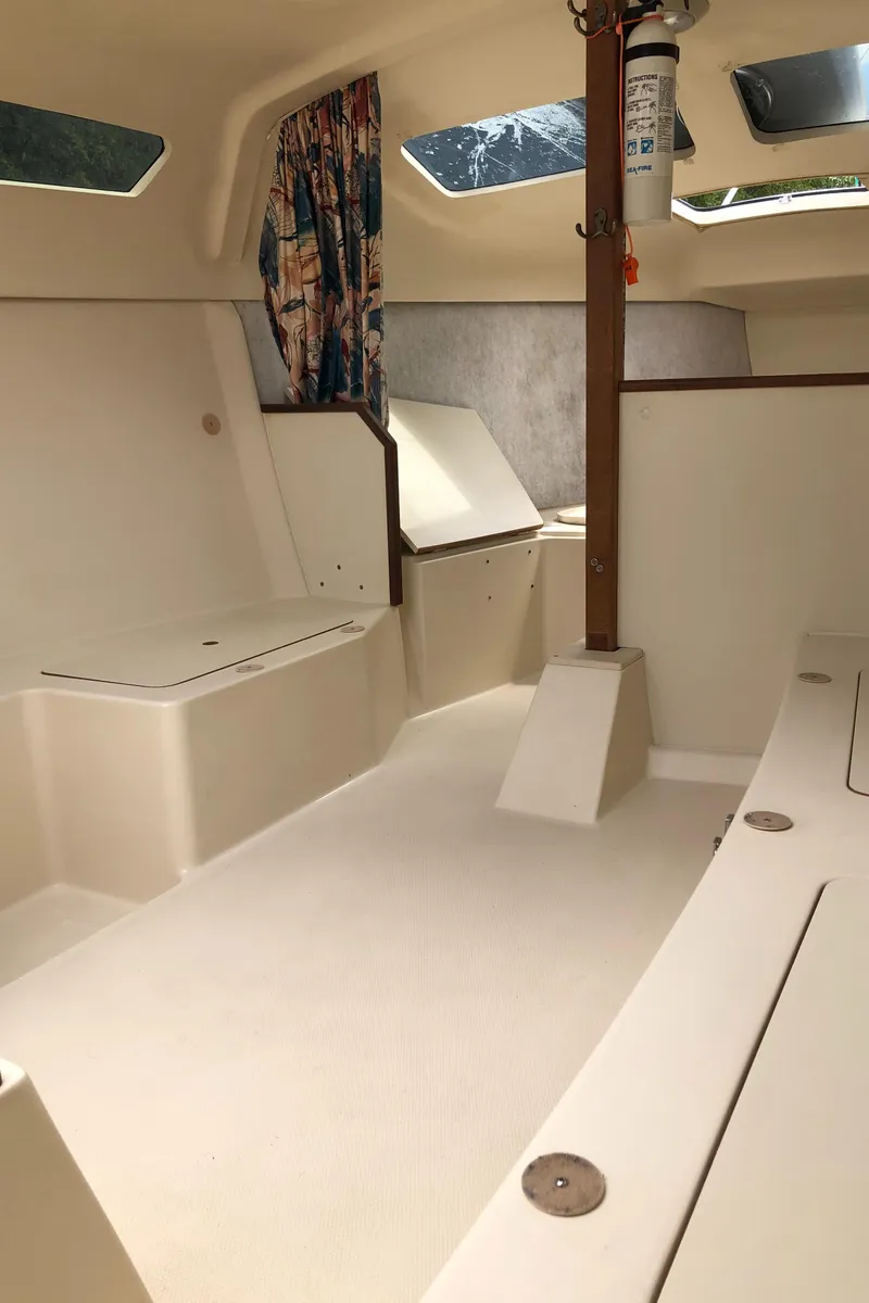 Slide: The Image of 1998 Hunter 240 sailboat interior with seating, windows, and storage compartments. - 20