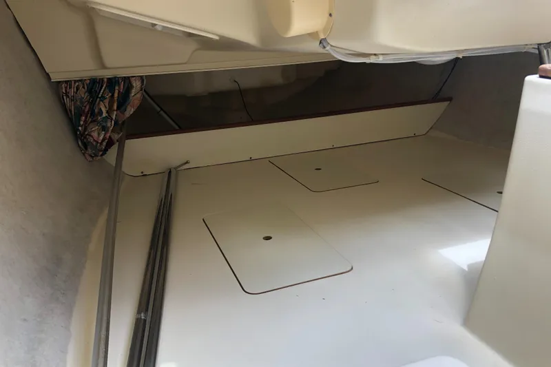 Slide: The Image of Interior of a 1998 Hunter 240 sailboat, featuring storage compartments and a clean, spacious layout. - 22