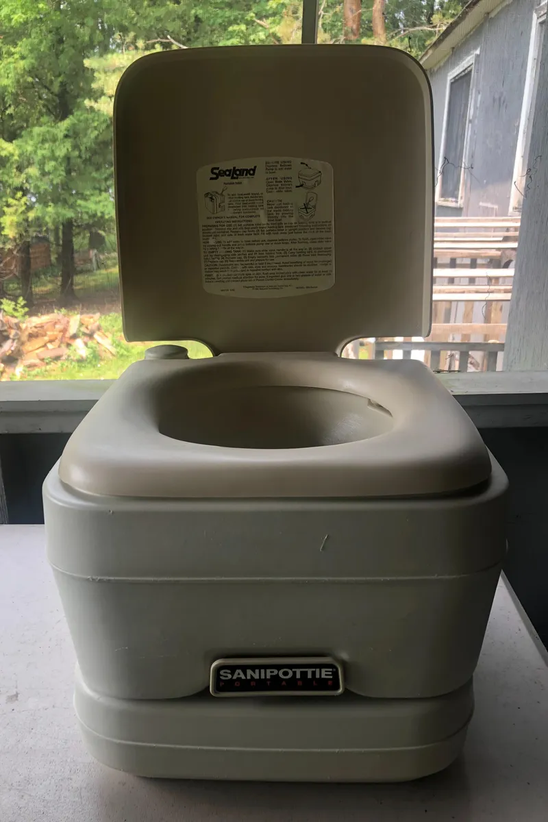 Slide: The Image of Portable toilet on porch, Hunter 240 model, 1998, with open lid. - 34