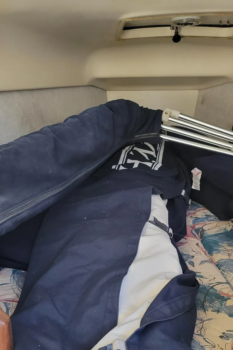 Slide: The Image of Interior of a 1998 Hunter 240 sailboat with folded sails and equipment. - 4