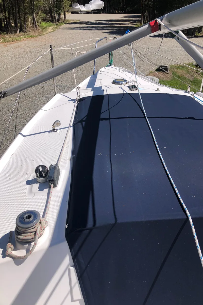 Slide: The Image of Hunter 240 sailboat deck, 1998 model, with rigging and winch, parked on gravel. - 7