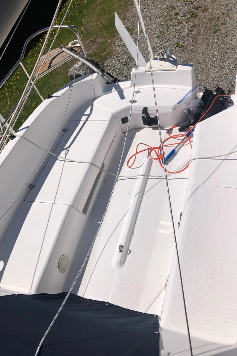 Slide: The Image of 1998 Hunter 240 sailboat cockpit with ropes and seating, viewed from above. - 8