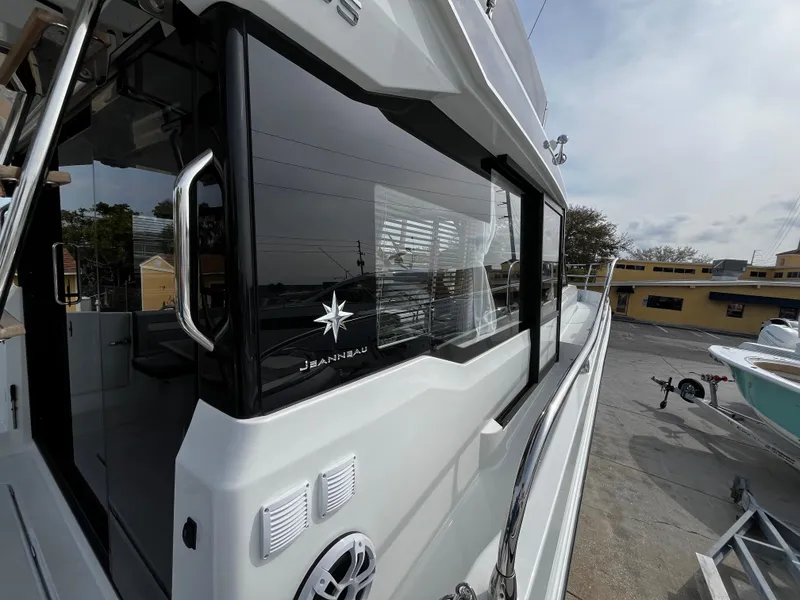 Slide: The Image of 2024 Jeanneau NC Weekender 1295 Fly exterior view at dock. - 11