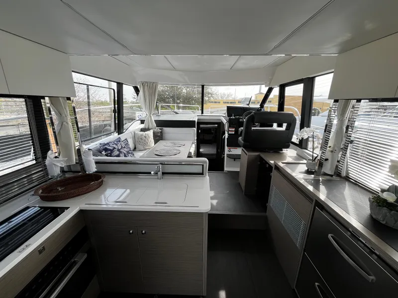 Slide: The Image of Interior of 2024 Jeanneau NC Weekender 1295 Fly yacht with modern kitchen and seating area. - 12