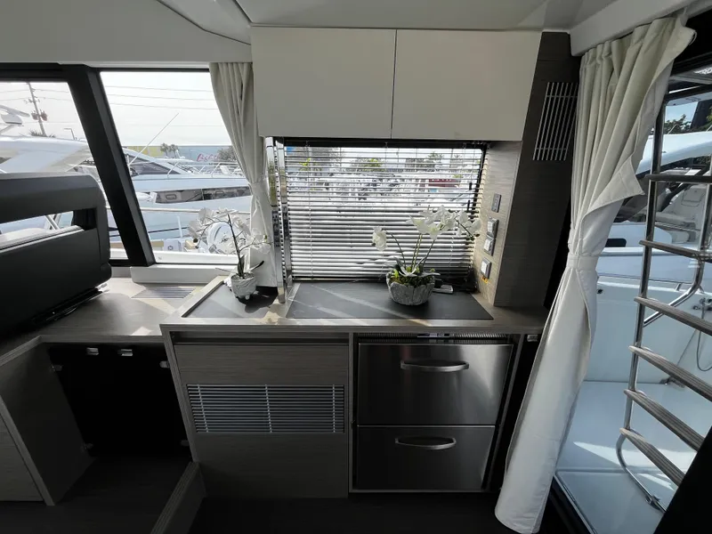 Slide: The Image of Modern kitchen area in 2024 Jeanneau NC Weekender 1295 Fly yacht. - 14