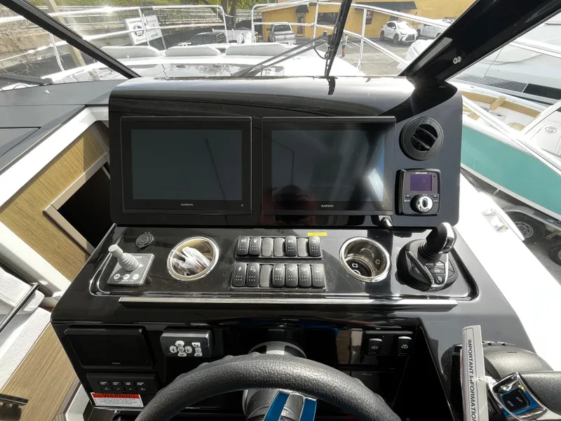 Slide: The Image of Helm station of 2024 Jeanneau NC Weekender 1295 Fly with dual displays and controls. - 17