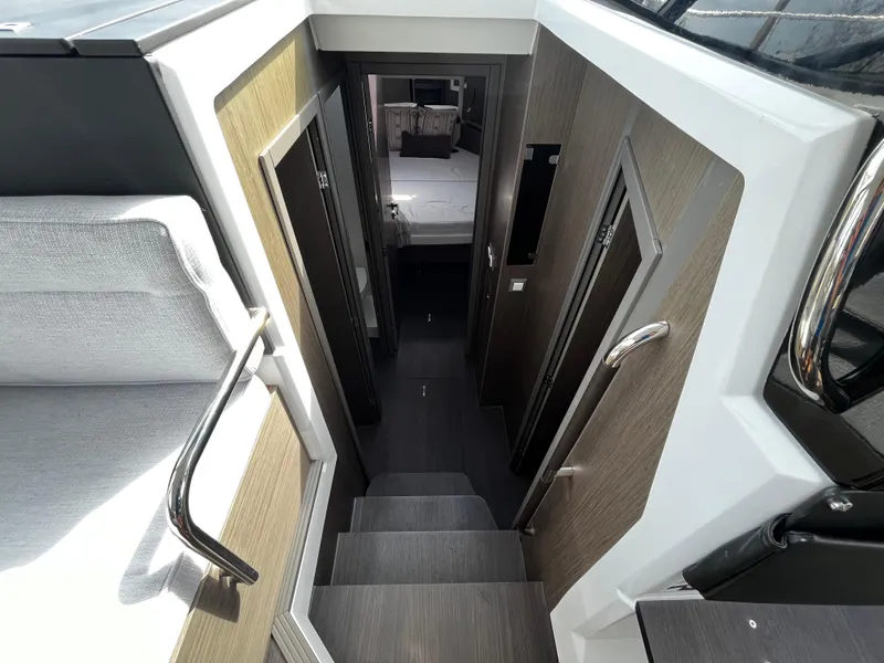Slide: The Image of Interior view of 2024 Jeanneau NC Weekender 1295 Fly, showing stairs and cabin. - 18
