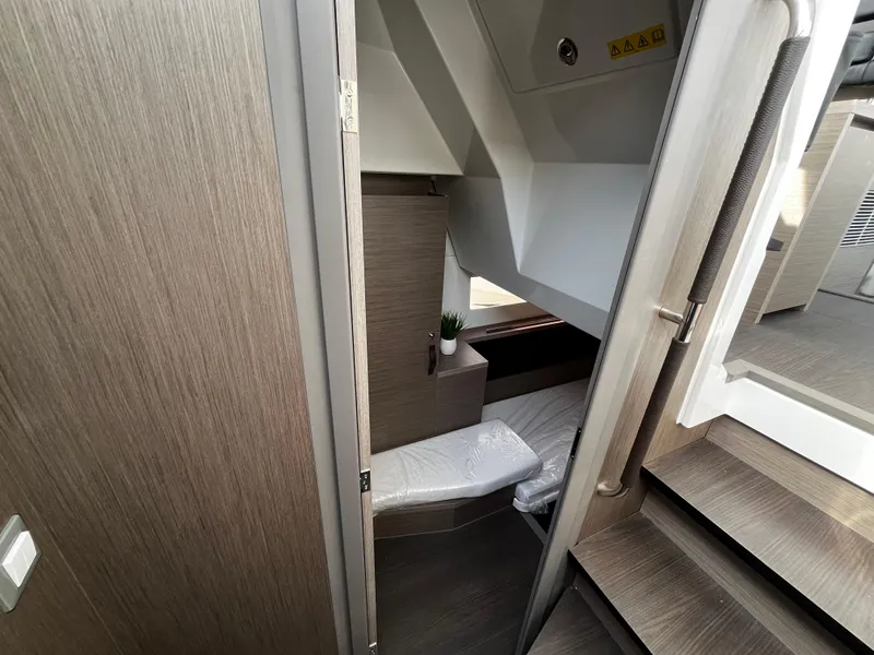 Slide: The Image of 2024 Jeanneau NC Weekender 1295 Fly cabin interior with modern wood finish. - 19