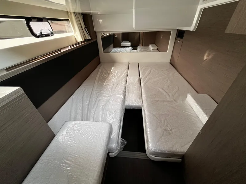 Slide: The Image of 2024 Jeanneau NC Weekender 1295 Fly interior cabin with beds and window. - 20