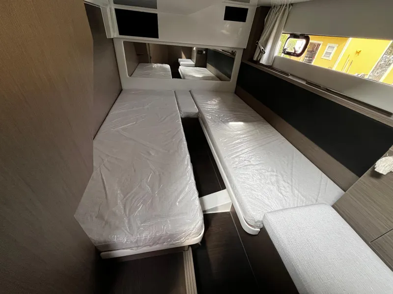 Slide: The Image of 2024 Jeanneau NC Weekender 1295 Fly cabin interior with twin beds and modern design. - 22