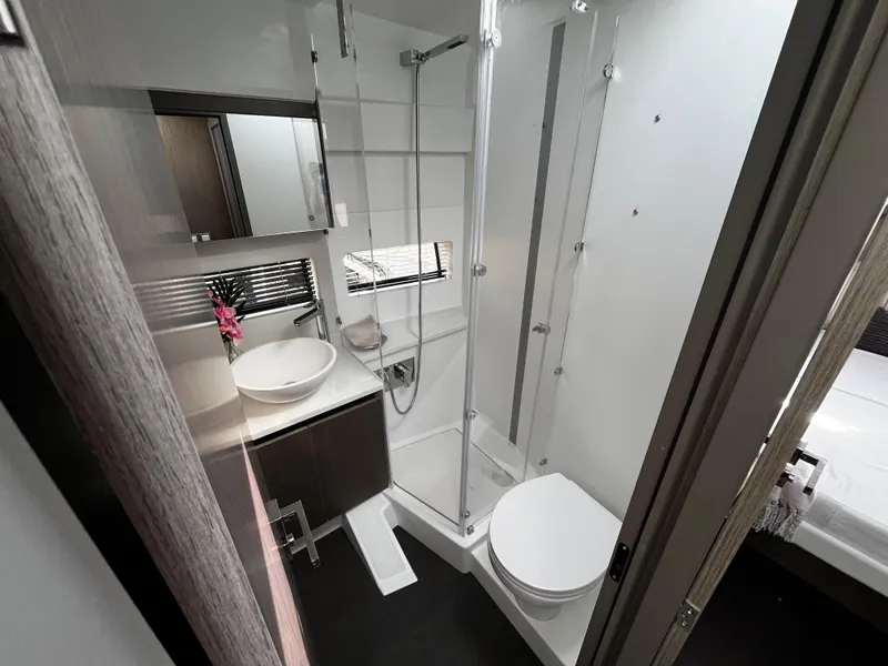 Slide: The Image of Modern bathroom in 2024 Jeanneau NC Weekender 1295 Fly boat with shower, sink, and toilet. - 23