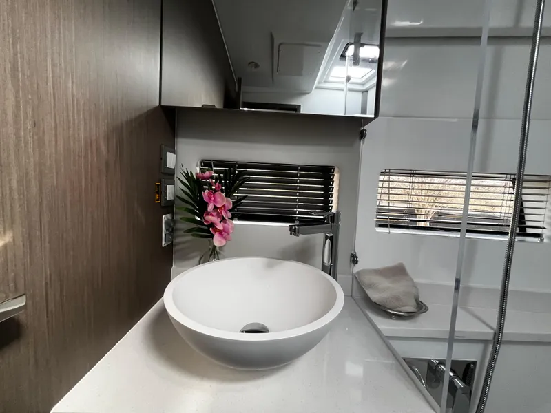 Slide: The Image of Modern bathroom in 2024 Jeanneau NC Weekender 1295 Fly yacht with vessel sink and floral decor. - 24