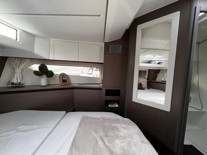 Slide: The Image of 2024 Jeanneau NC Weekender 1295 Fly cabin interior with modern decor and natural light. - 28