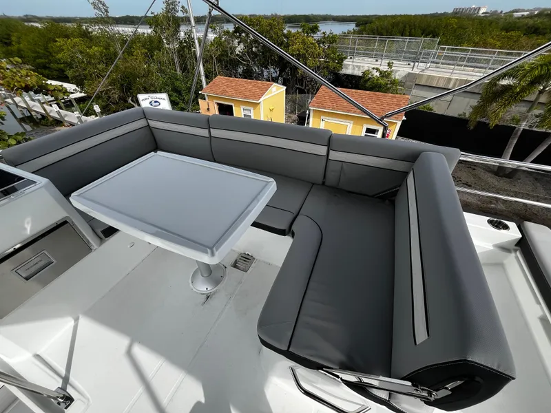 Slide: The Image of 2024 Jeanneau NC Weekender 1295 Flybridge seating area with table. - 35