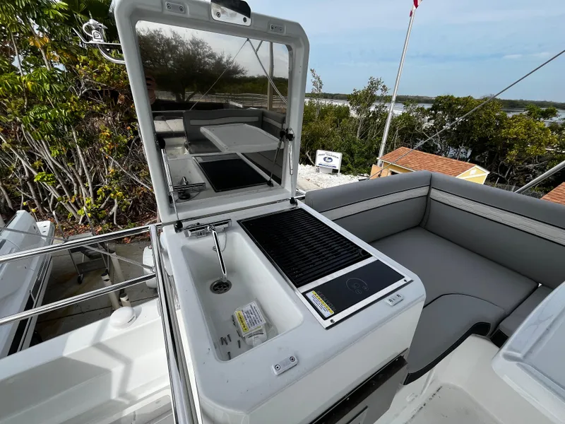 Slide: The Image of 2024 Jeanneau NC Weekender 1295 Fly outdoor kitchen and seating area. - 36