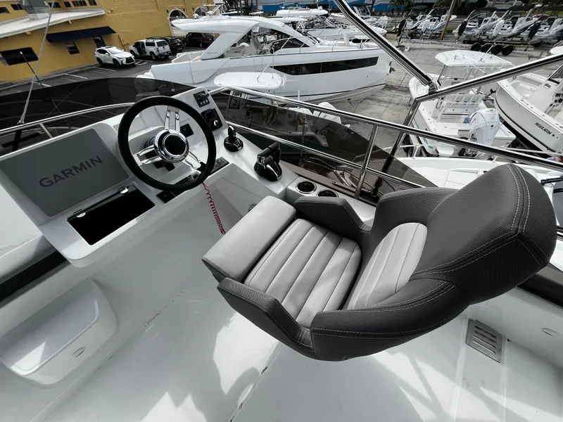 Slide: The Image of Helm station of 2024 Jeanneau NC Weekender 1295 Fly with Garmin navigation system. - 39