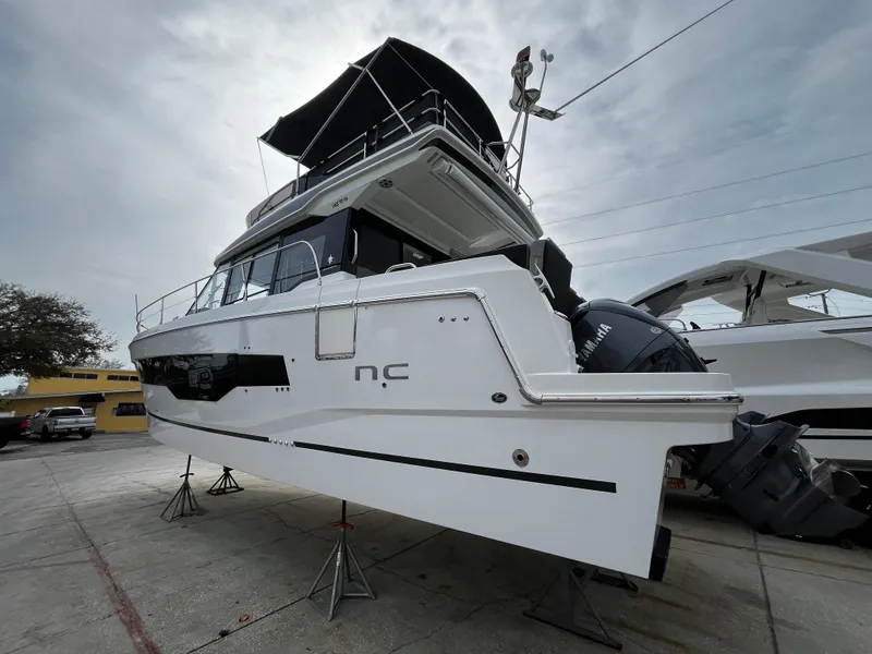 Slide: The Image of 2024 Jeanneau NC Weekender 1295 Fly on display at a marina. - 4