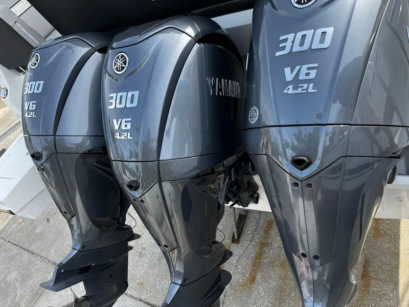 Slide: The Image of Triple Yamaha 300 V6 4.2L outboard engines on a 2024 Jeanneau NC Weekender 1295 Fly. - 6