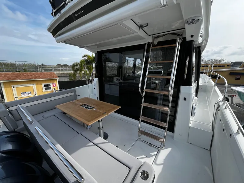 Slide: The Image of 2024 Jeanneau NC Weekender 1295 Fly - outdoor seating and ladder. - 7