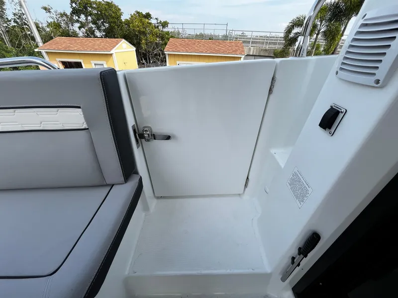 Slide: The Image of 2024 Jeanneau NC Weekender 1295 Fly boat interior with seating and door. - 9