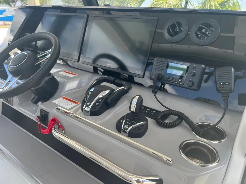 Slide: The Image of 2024 Jeanneau Leader 10.5 CC helm with dual screens and advanced controls. - 13