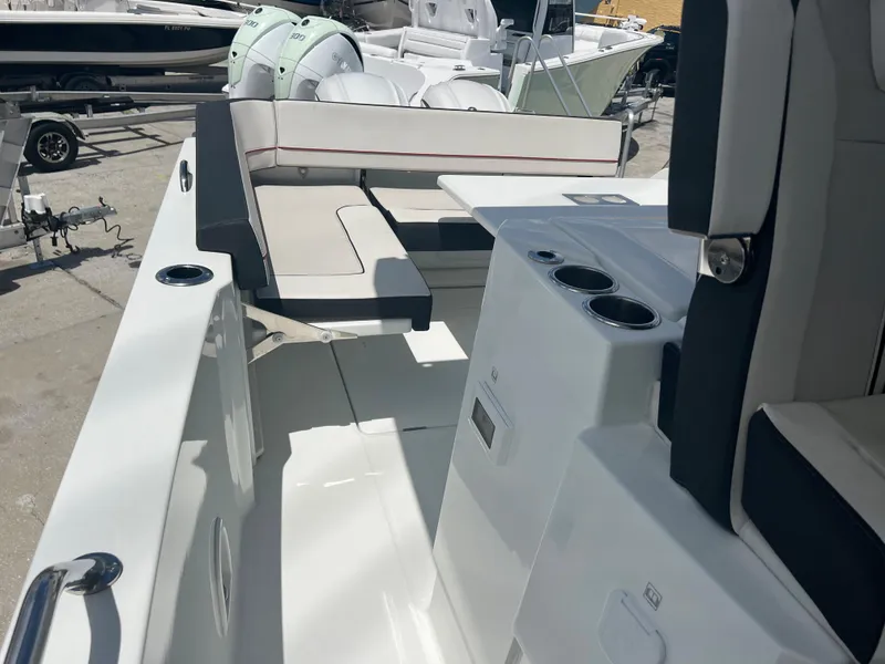 Slide: The Image of 2024 Jeanneau Leader 10.5 CC boat interior with seating and cup holders. - 14