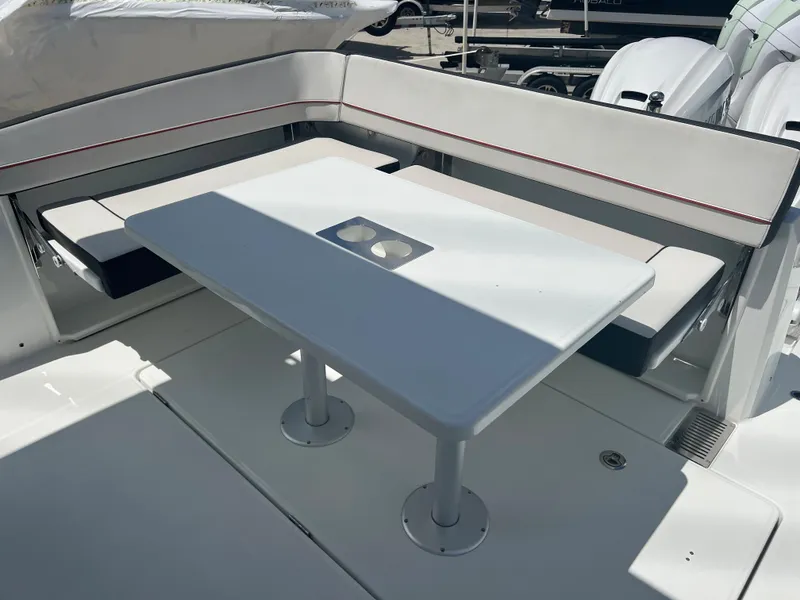 Slide: The Image of 2024 Jeanneau Leader 10.5 CC boat with white seating and table in the cockpit. - 18