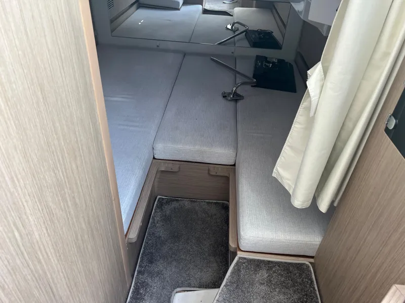 Slide: The Image of 2024 Jeanneau Leader 10.5 CC cabin interior with grey cushions and carpet. - 20