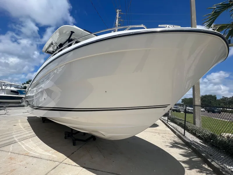 Slide: The Image of 2024 Jeanneau Leader 10.5 CC boat on display under a clear blue sky. - 3