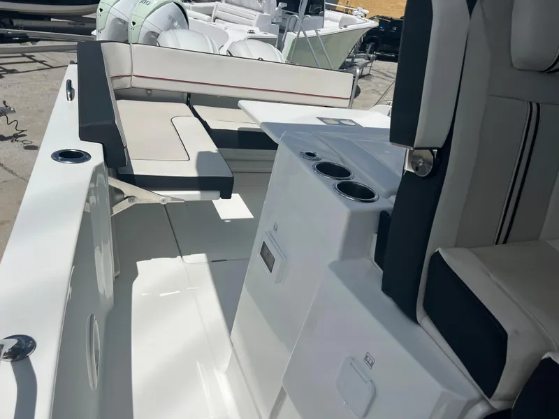 Slide: The Image of 2024 Jeanneau Leader 10.5 CC boat interior with seating and cup holders. - 5