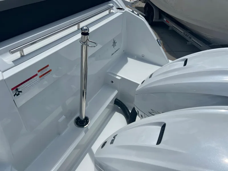 Slide: The Image of 2024 Jeanneau Leader 10.5 CC boat stern with dual outboard engines. - 8
