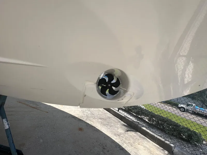 Slide: The Image of 2024 Jeanneau NC Sport 895 boat on stands, side view under clear blue sky. - 5