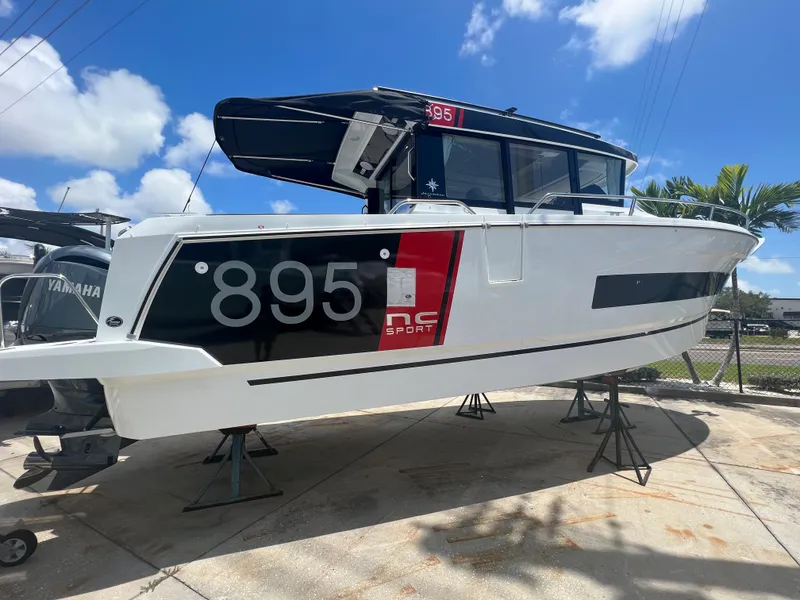Slide: The Image of 2024 Jeanneau NC Sport 895 boat on display under a sunny sky. - 29