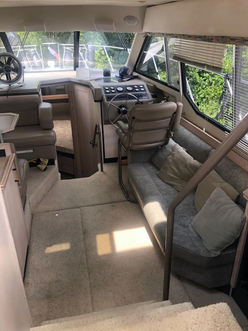 Slide: The Image of Interior of 1996 Bayliner 3587 Motoryacht with seating, helm, and windows. - 17