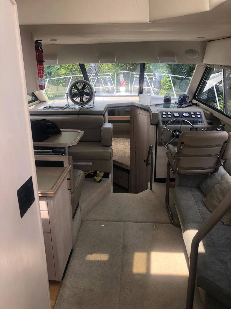 Slide: The Image of Interior of 1996 Bayliner 3587 Motoryacht, featuring helm, seating, and dining area. - 18