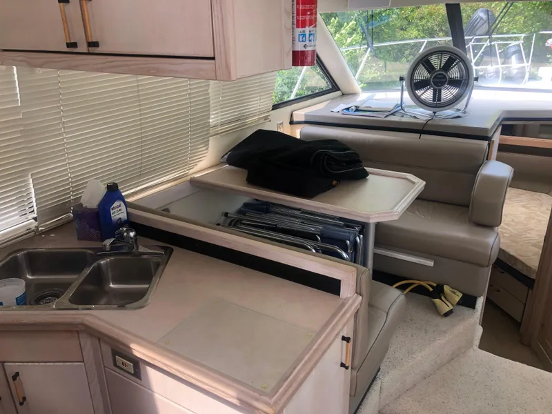 Slide: The Image of Interior of 1996 Bayliner 3587 Motoryacht with kitchen and seating area. - 19