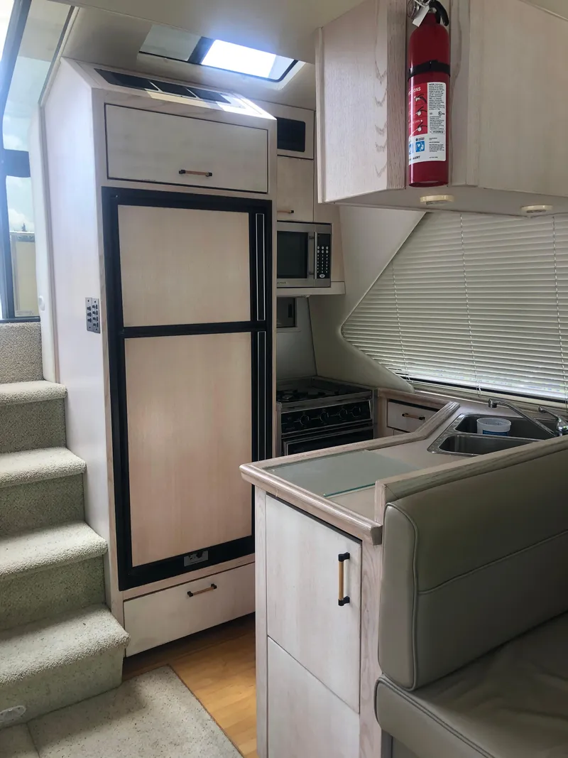 Slide: The Image of Interior of 1996 Bayliner 3587 Motoryacht with kitchen and seating area. - 21