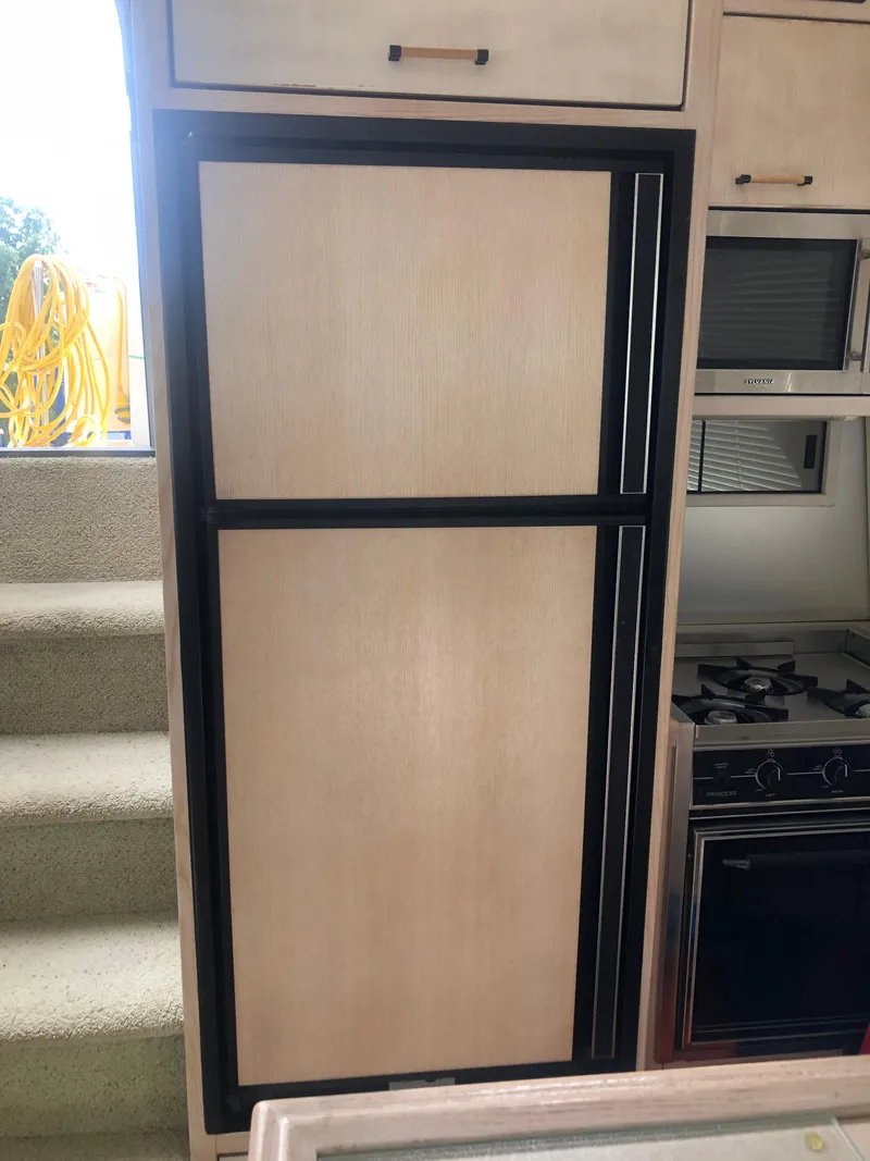 Slide: The Image of 1996 Bayliner 3587 Motoryacht interior with refrigerator and stove. - 22